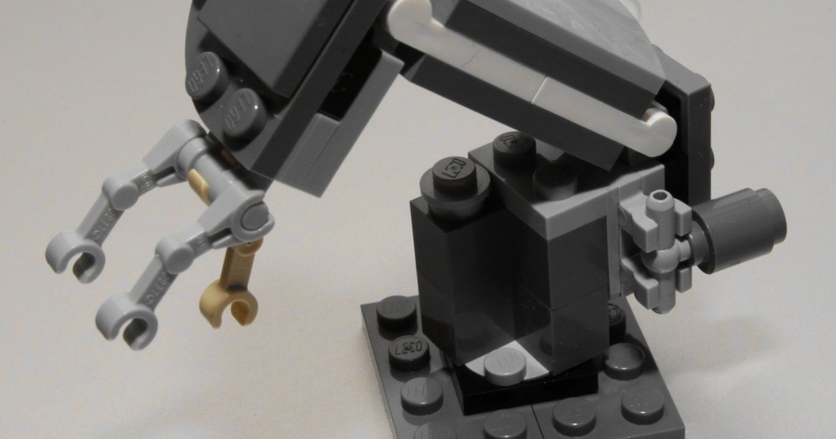 A robotic arm built from bricks: automated trading follows rules, it does not guess the future